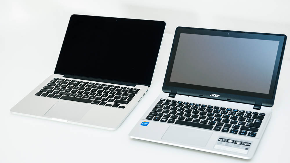 LONDON, UNITED KINGDOM - Apple Mac Book pro and Acer Aspire laptop notebook next to eachoterh on white table